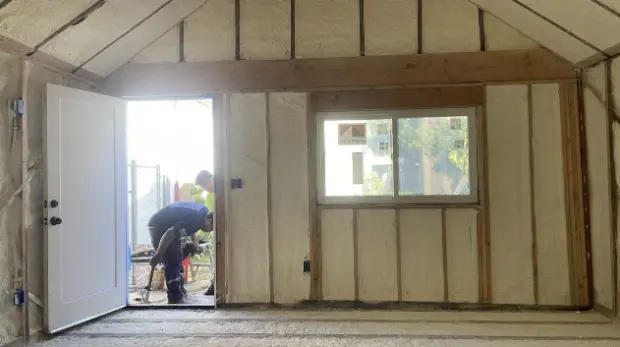  Construction workers installing insulation in a green building project, complying with San Francisco's green building code.


              