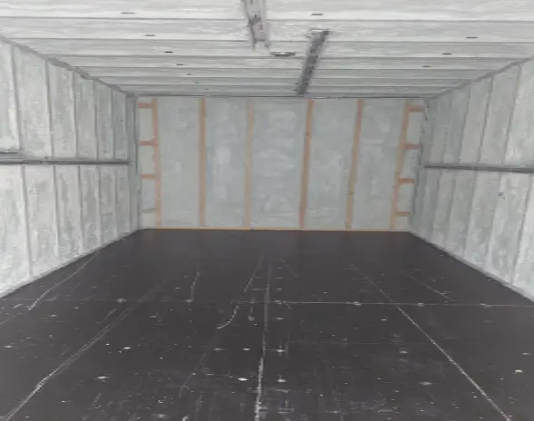 Spray foam insulation inside a cold storage room, showing detailed coverage.