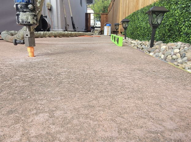 Close-up of polyurethane foam injection into a concrete driveway during insulation and leveling work in San Jose.

              