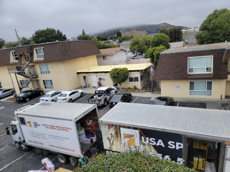   USA Spray Me trucks parked outside a residential area in San Francisco, preparing for a spray foam insulation project.
                        