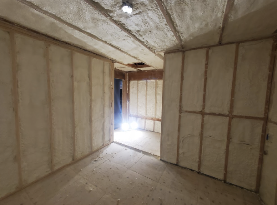  
   A wine cellar under construction with fiberglass insulation installed on the walls.

   