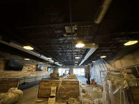  
         Interior view of a meat processing plant under construction with spray foam insulation on the ceiling.


         