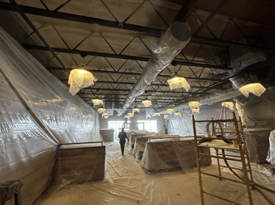  
         Spray foam insulation being installed in a meat processing plant.
         