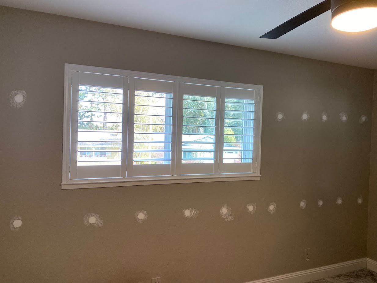  
         Interior view of a residential wall showing installed insulation patches.
         