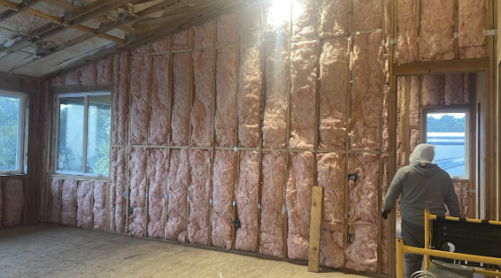  Fiberglass insulation being installed in a residential property.

                     