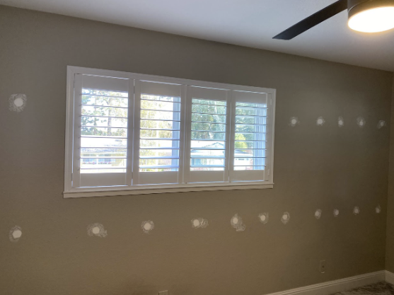  
                  Interior view of a residential wall showing installed insulation patches.
                  