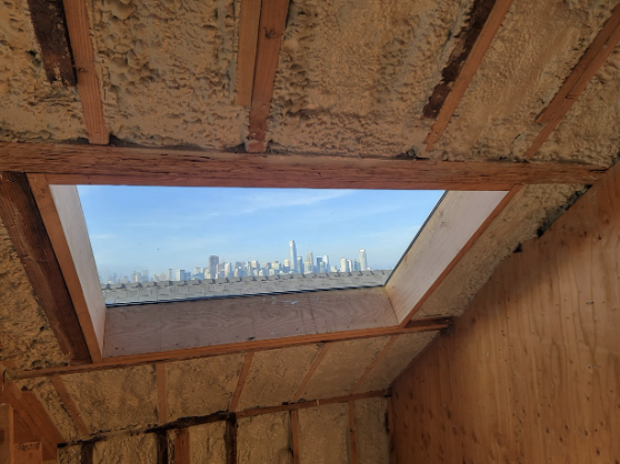  
         
         View of a ceiling and walls insulated with spray foam.

         