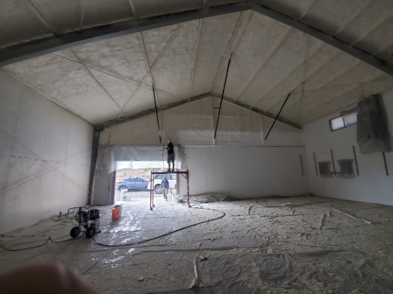  
                 
                  Spray foam insulation being applied to the ceiling of a commercial building in San Jose to enhance energy efficiency.
                  