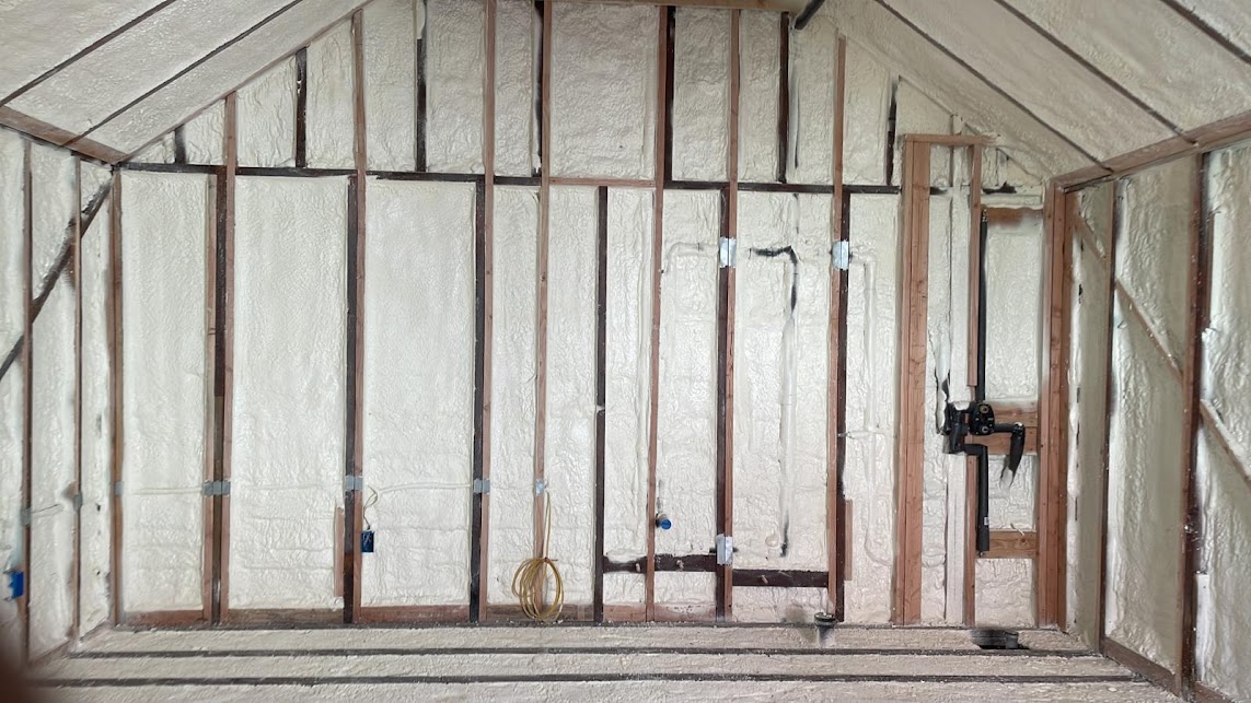  

                     Framed walls with spray foam insulation applied inside a wine cellar under construction.

                     