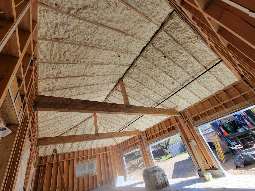  


                     Fiberglass insulation installed between wooden framing inside a house.




                     