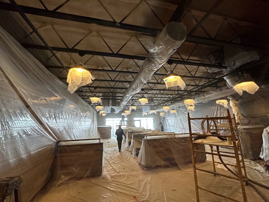  


                     Commercial space covered in protective sheets during insulation preparation.





                     