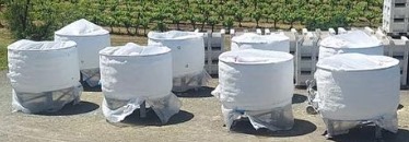  
               Insulated wine tanks covered with protective material outdoors.




      
      
      
               