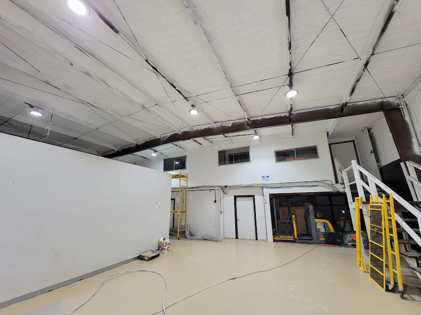  


                     Interior view of a commercial building with spray foam insulation applied to walls and ceiling.





                     