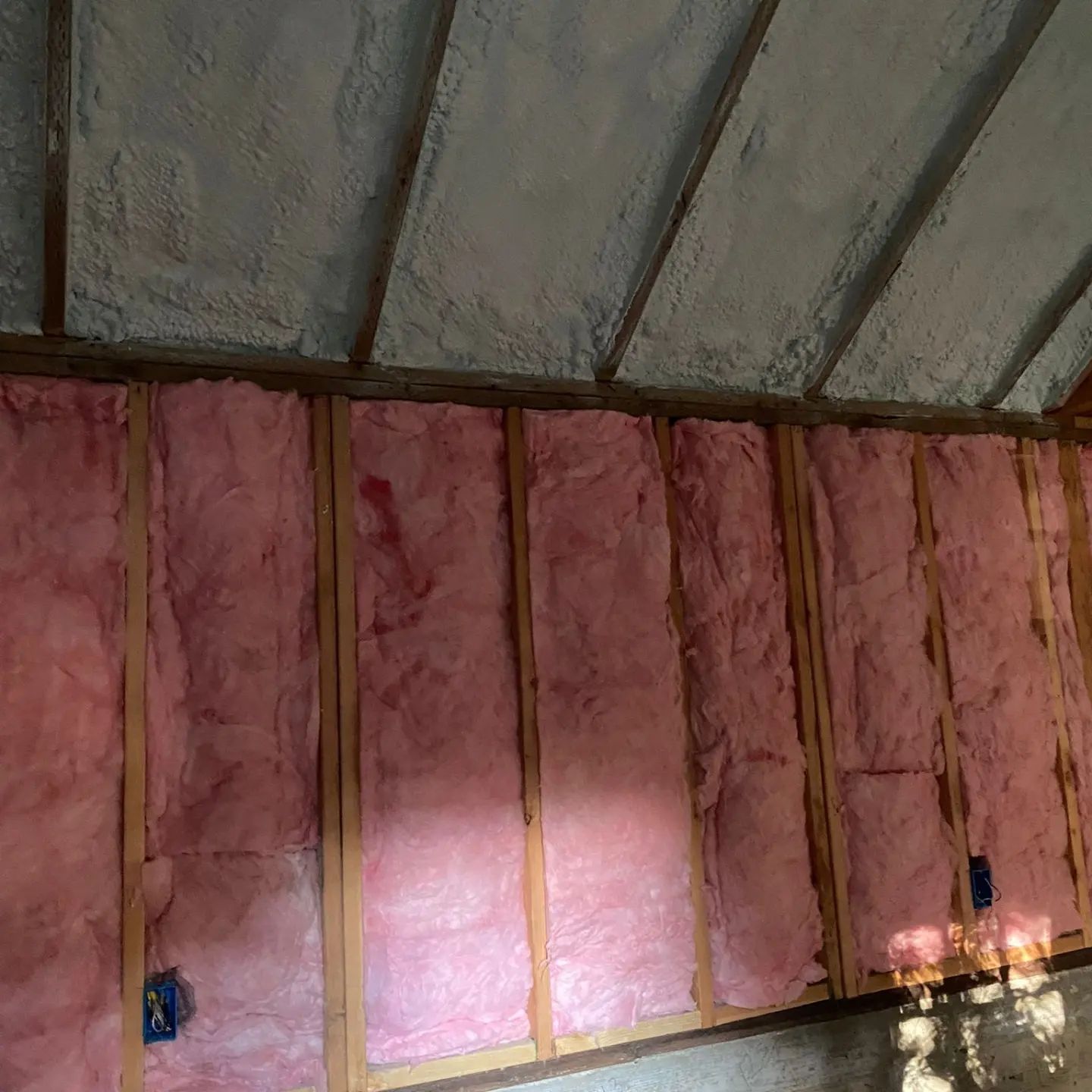  


               Wall with both spray foam and fiberglass insulation in a building.

      
               