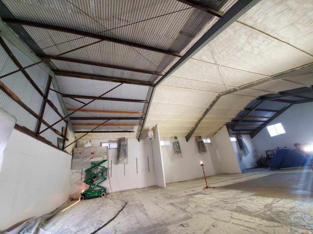  

                     Large commercial building with spray foam insulation applied to the curved ceiling






                     