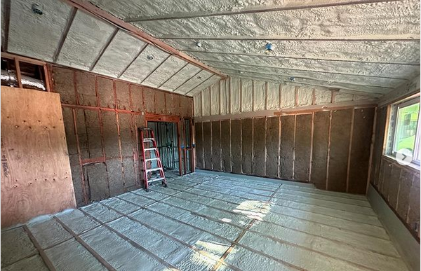  

                     Room insulated with spray foam on the roof and walls, showing a clean installation setup.






                     