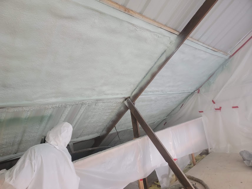  
               
               

               USA Spray Me worker in protective gear applying spray foam insulation on a sloped roof.
      
      
      
               