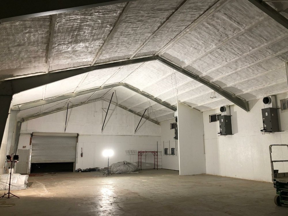  

                    Large warehouse with spray foam insulation applied to the ceiling and walls.






                     