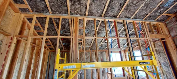 Interior renovation of a recycling center with insulation in progress