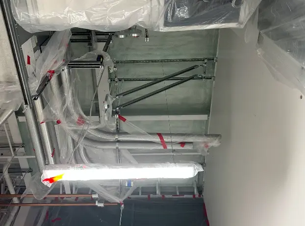 Spray foam insulation applied to the ceiling and walls of a recycling center