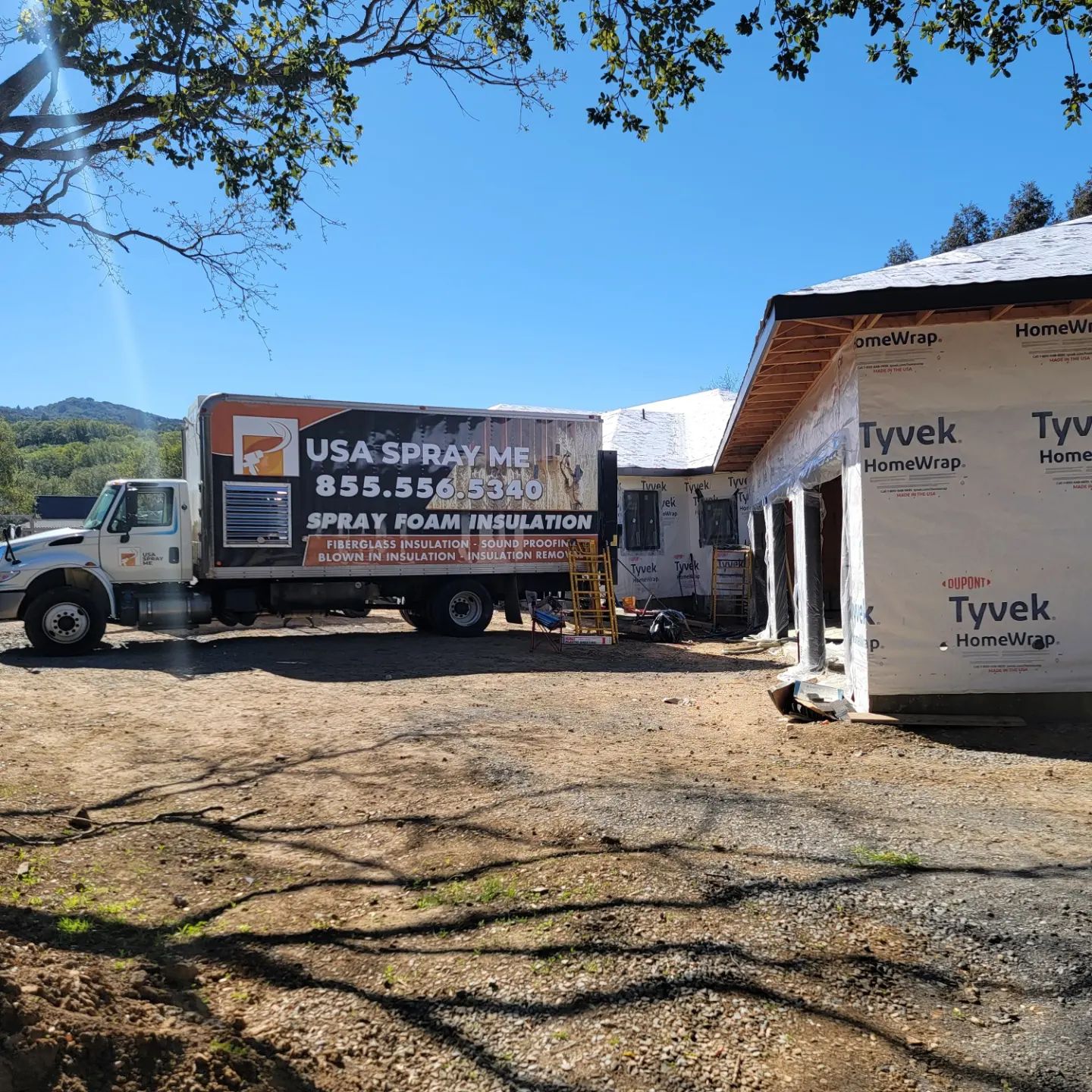  

                  USA Spray Me truck parked next to a house under construction.





                  