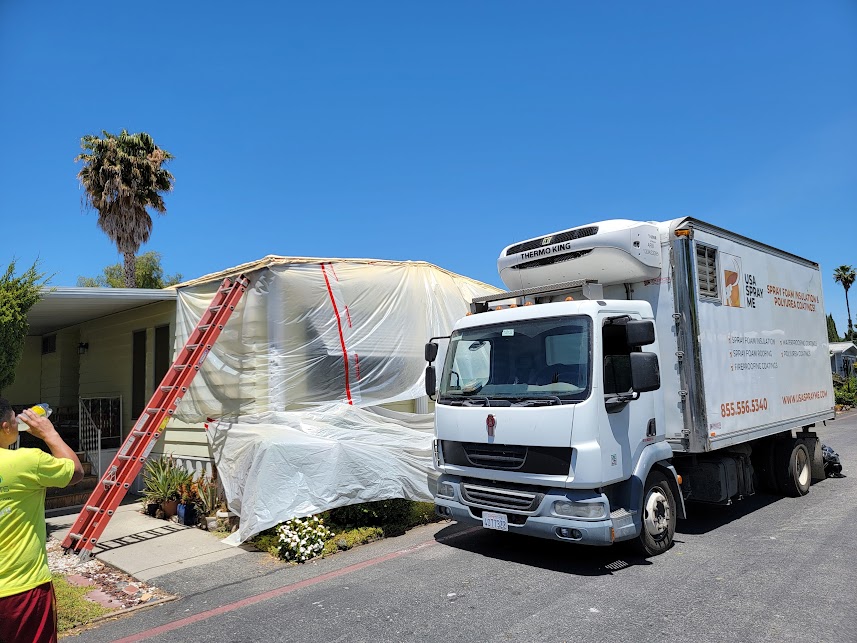  

                  A truck with USA Spray Me branding parked next to a residential property.








                  