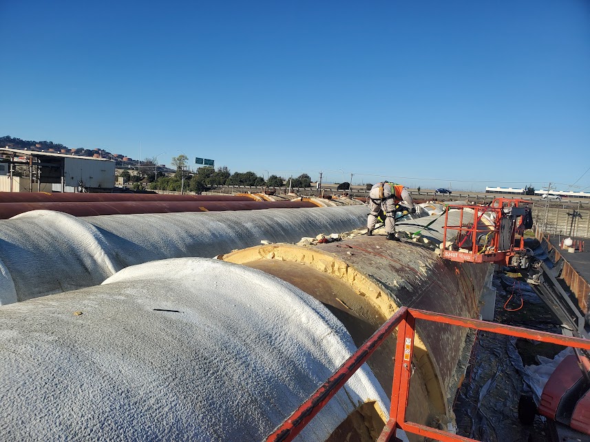  

                   
                  Technicians working on top of large cylindrical cold storage tanks to apply spray polyurethane foam insulation.



                  