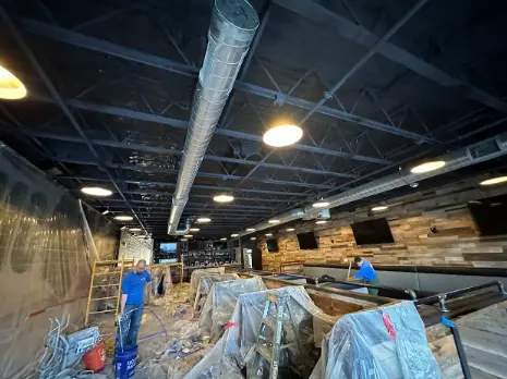 Workers prepare a restaurant for insulation