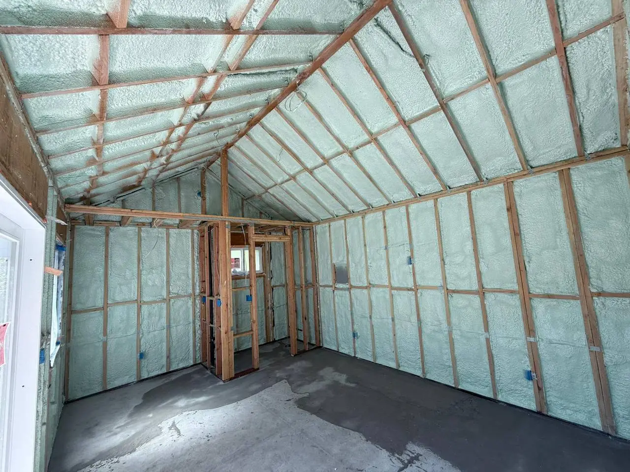 Interior of a commercial building in San Mateo with spray foam insulation applied to walls and roof.