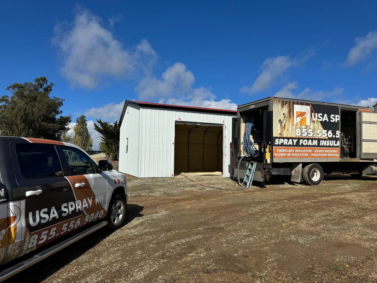 Interior of a residential building in Hayward with spray foam insulation applied to walls and ceiling, wooden studs visible and concrete floor unfinished.