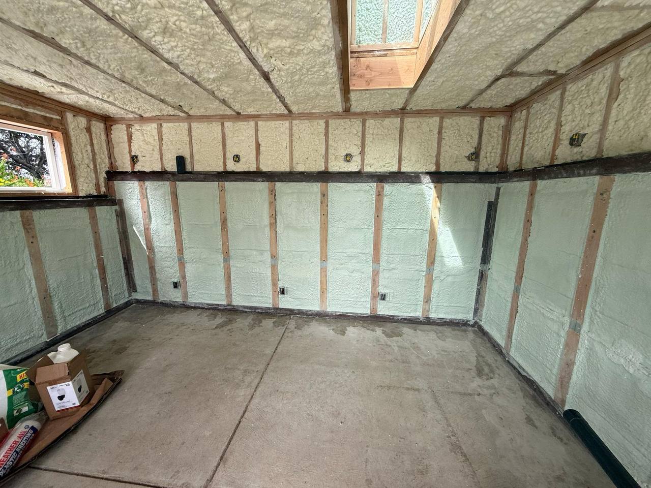 USA Spray Me service trucks parked outside a commercial building in Palo Alto.