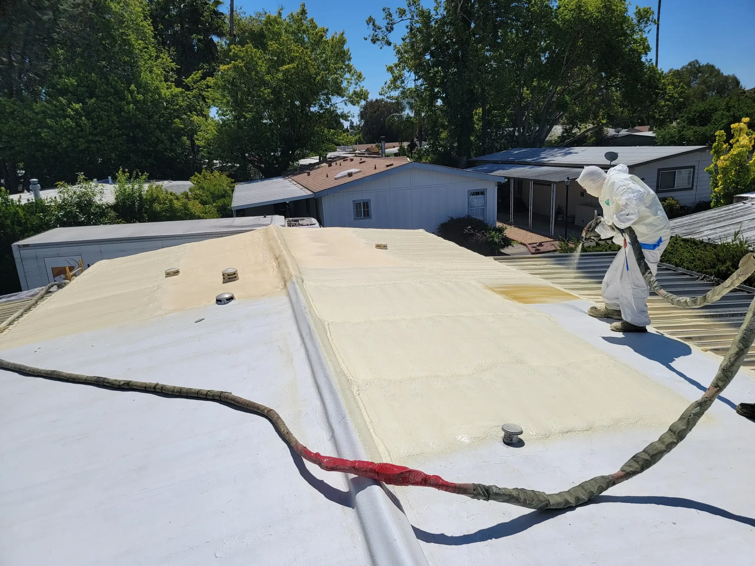 Spray foam roofing system protecting against roof leaks in California
