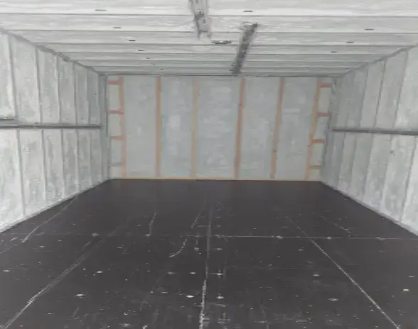 Spray foam insulation inside a cold storage room, showing detailed coverage.