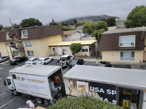  USA Spray Me trucks parked outside a residential area in San Francisco, preparing for a spray foam insulation project. 