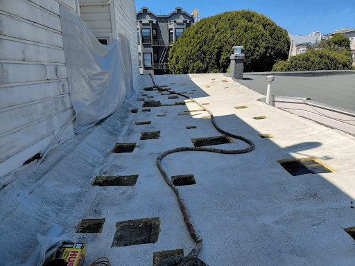 Roof of a custom home in Berkeley being prepared for spray foam insulation, with visible gaps ready to be sealed.