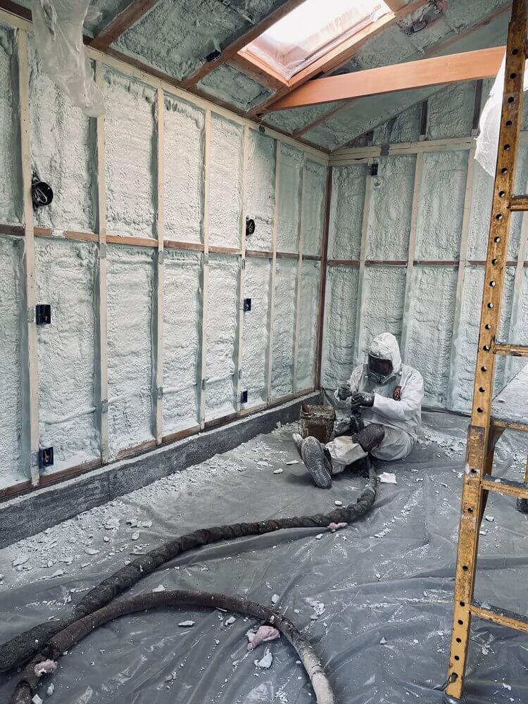 The installation of spray foam wall insulation.