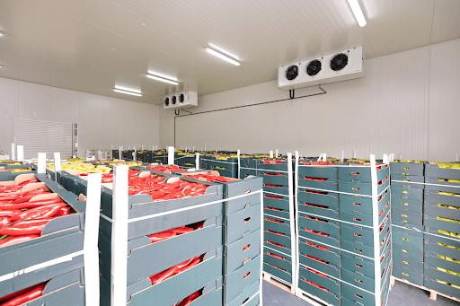 Insulated produce storage facility with artificial cooling system.