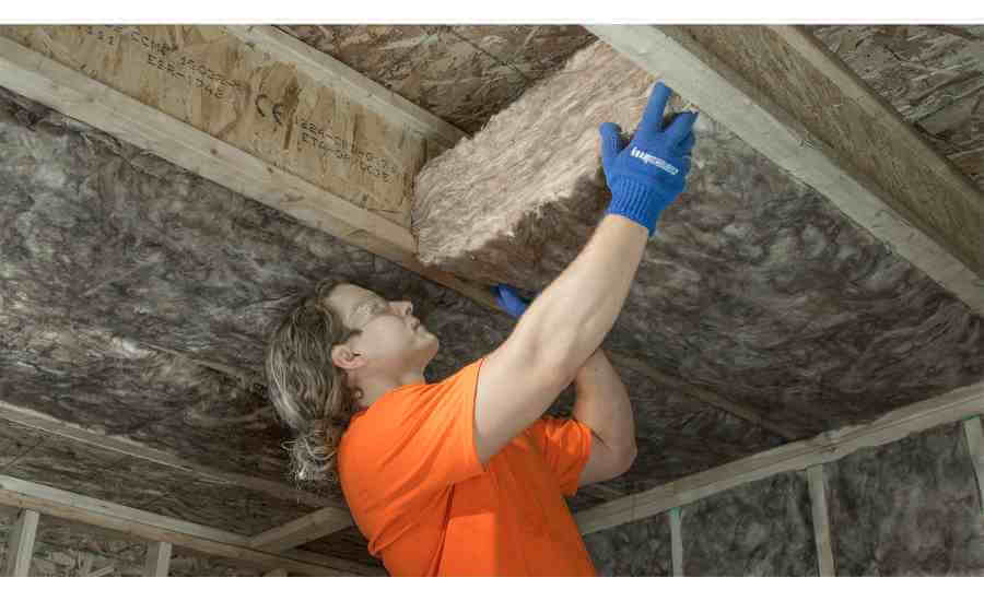 Installation of mineral wool attic insulation.
