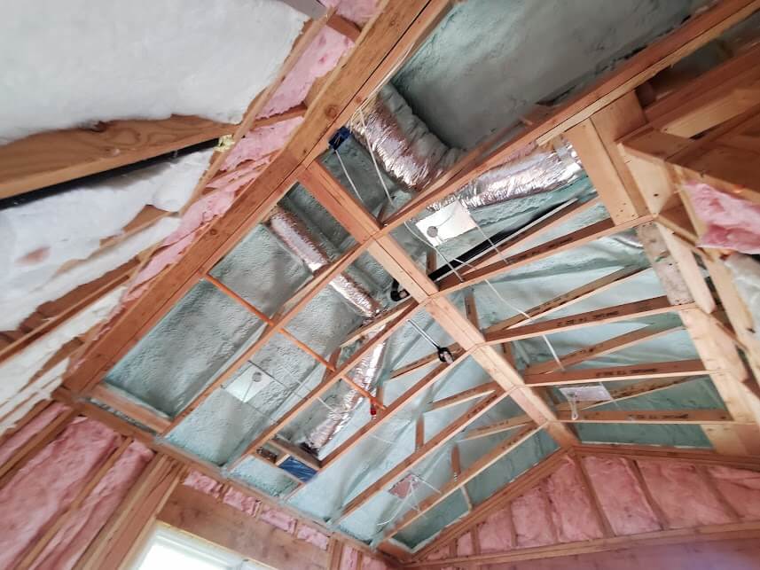 Installation of ceiling and walls with fiberglass and spray foam insulation in progress.