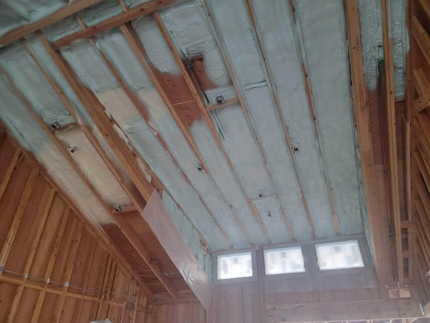 Spray foam insulation applied to a ceiling.