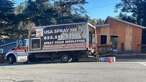 USA Spray Me truck parked outside a residential home for spray foam insulation service.