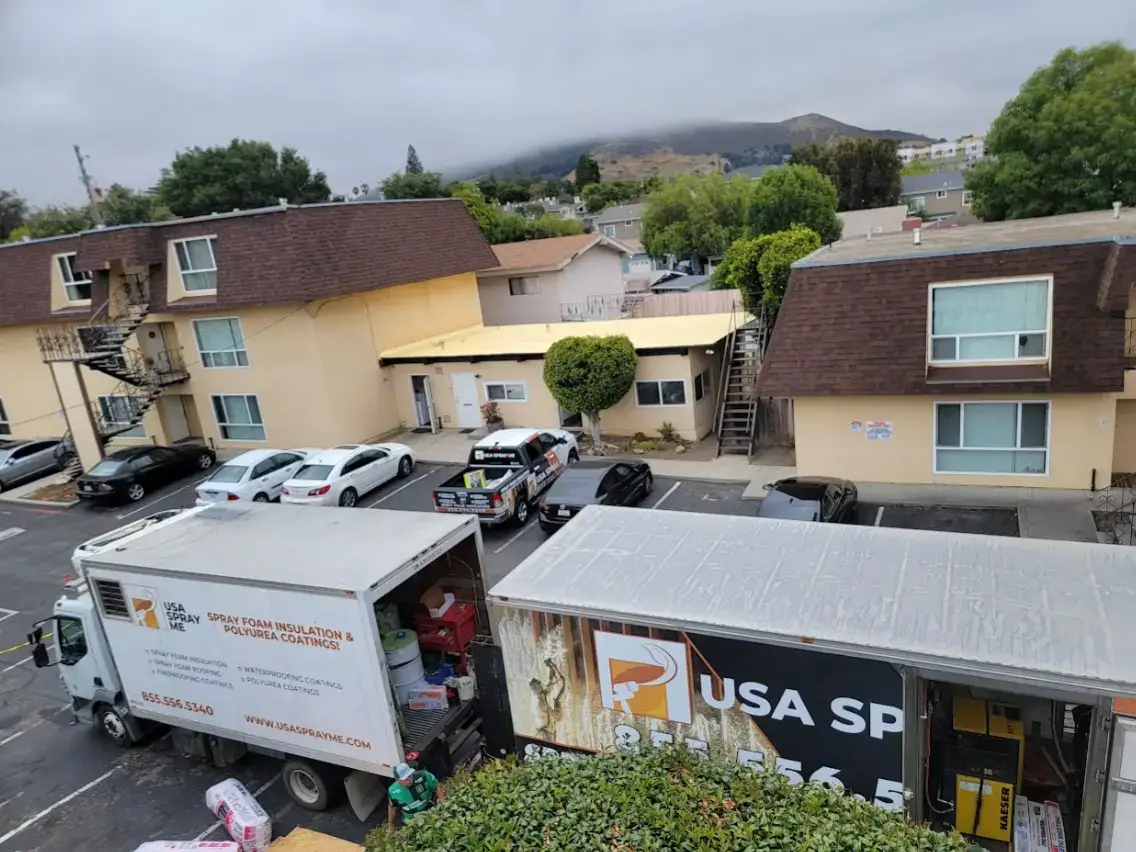 Spray foam insulation trucks parked in a residential area in San Francisco, ready to start a new home insulation project.